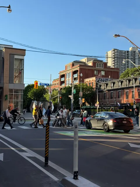 A Toronto intersection sits beneath a clear evening sky.