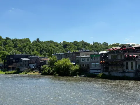 Historic stone buildings line the river in Elora, Ontario.