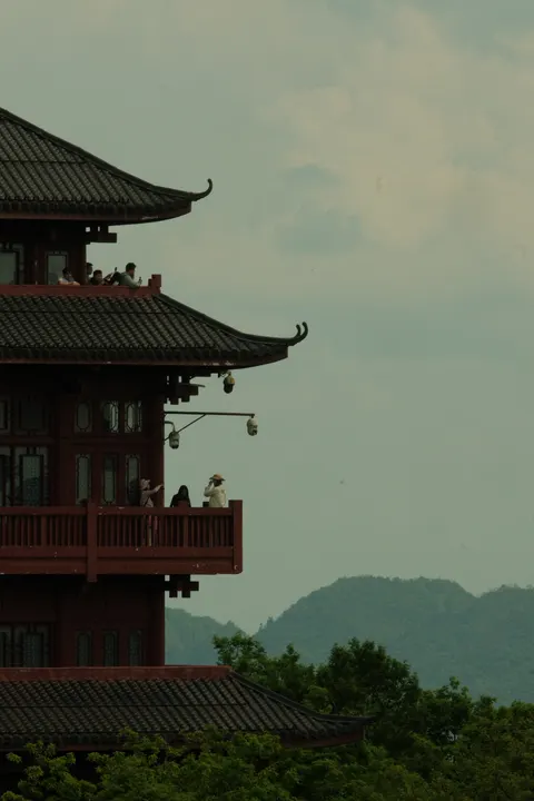 A traditional pavilion overlooks hazy mountain ridges in Zhangjiajie.