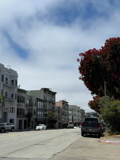 Low apartment buildings line a wide San Francisco avenue.